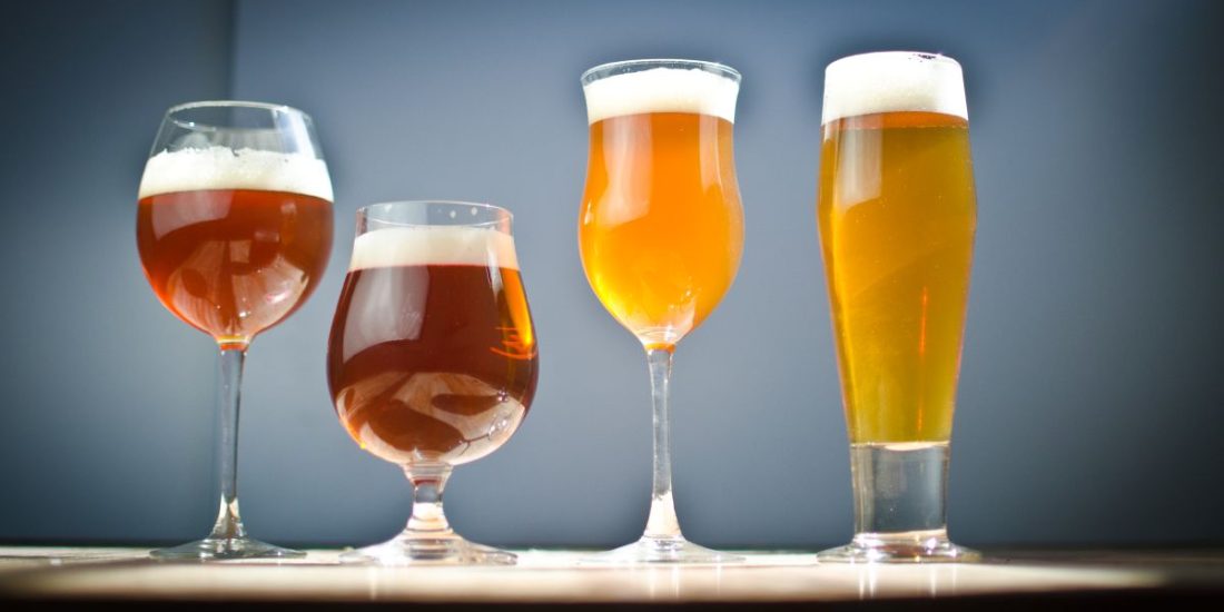 Four beer glasses of varying sizes
